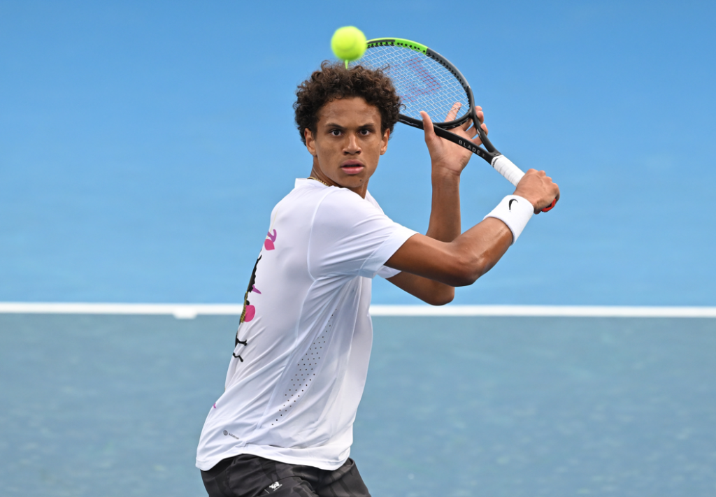 Gabriel Diallo prepares to hit a backhand volley.