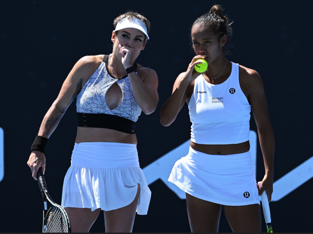 Bethanie Mattek-Sands and Leylah Fernadez talk on court.