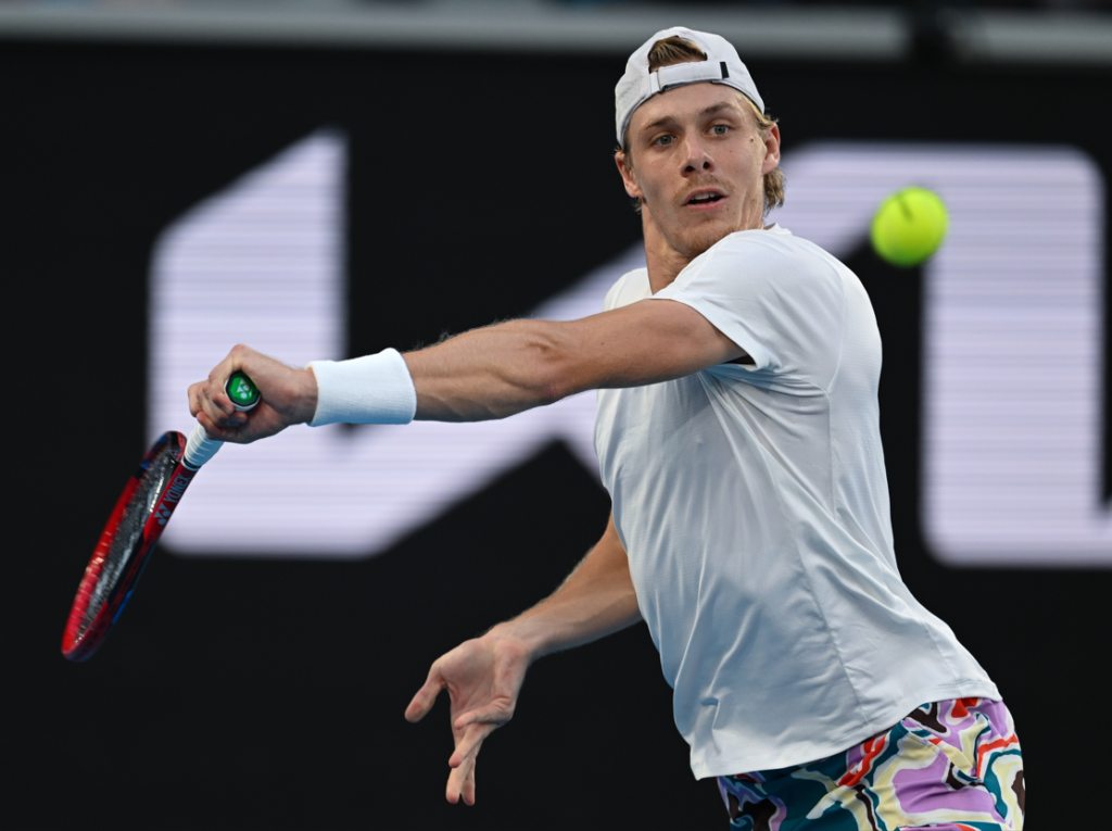 Denis Shapovalov prepares to hit a backhand.