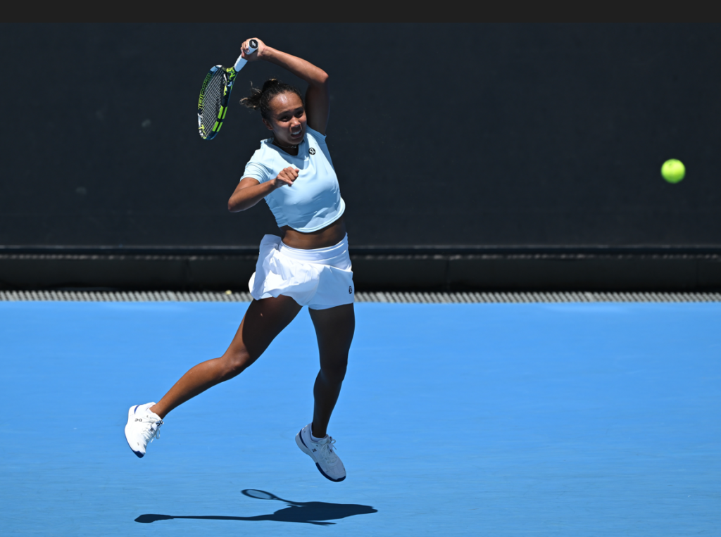Leylah Annie Fernandez leaps into the air after hitting a forehand.