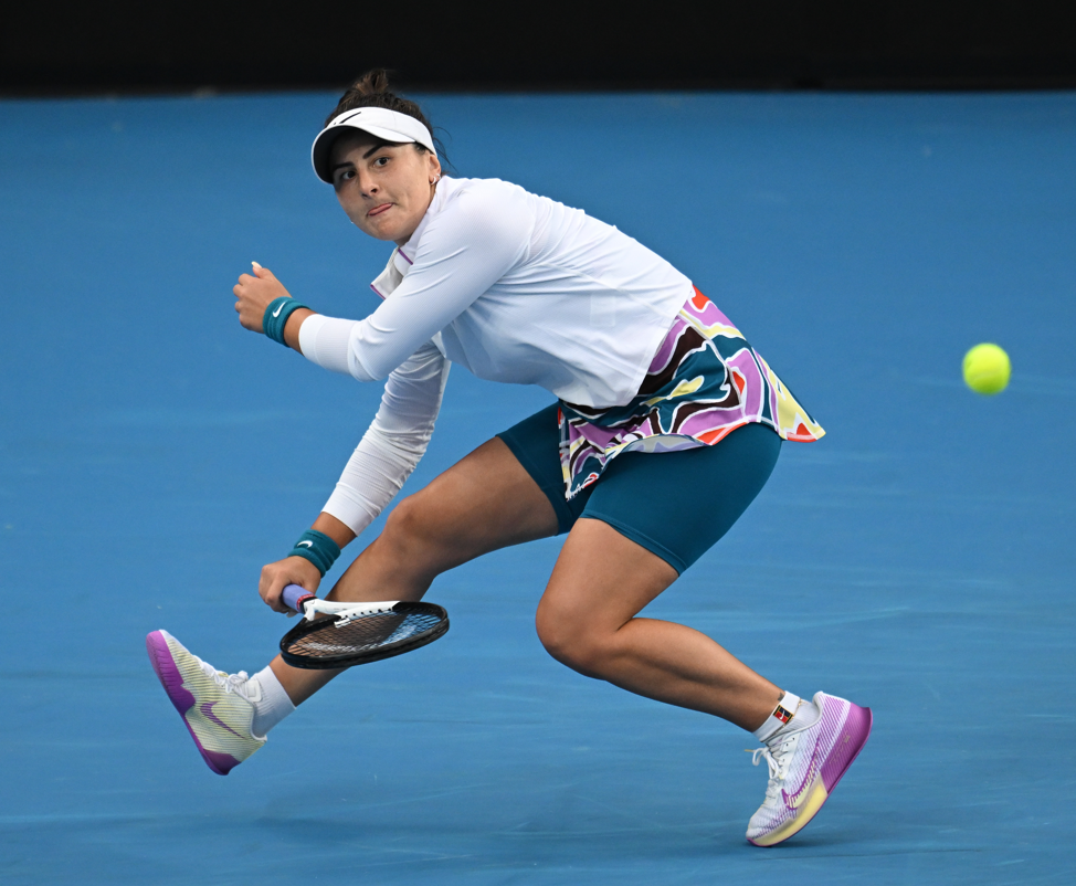 Bianca Andreescu scrambles as she follows through on a forehand.