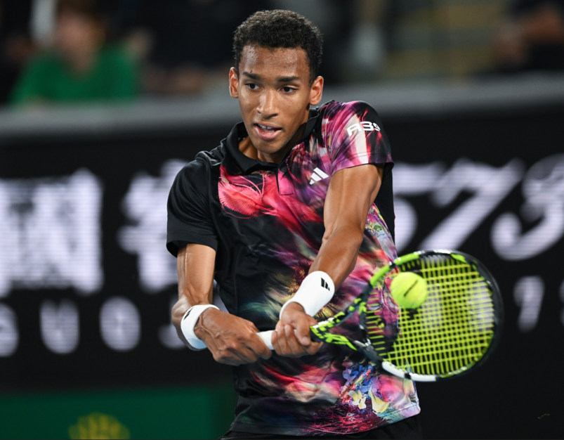Felix Auger-Aliassime hits a backhand.