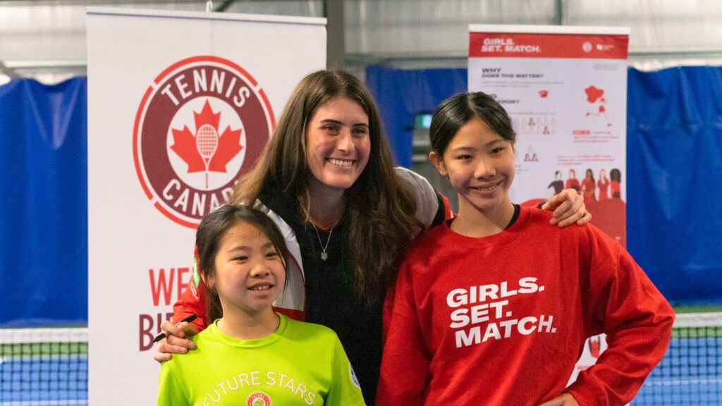 Rebecca Marino poses for a photo with two children.